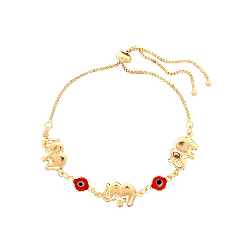 Introducing the Red Evil Eye Elephant Charm Bracelet: a 14k gold-filled accessory adorned with three elephant charms, two red circular accents, and an adjustable chain featuring a heart-shaped clasp.